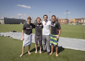 STHM sophomore Ben Baker, third from left, and his friends, who will attempt to break a Slip ’N Slide world record, recently took a test run at Temple University’s Geasey Field. (Betsy Manning)