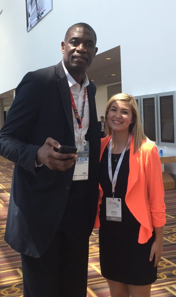  STHM student Katie Rose Augustine with NBA legend Dikembe Mutombo.