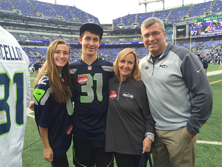 STHM alumnus Todd Brunner, far right, serves as a scout for the NFL’s Seattle Seahawks. Joining him on the sideline at a recent game were his daughter Annie, son Chad, and wife Nancy.