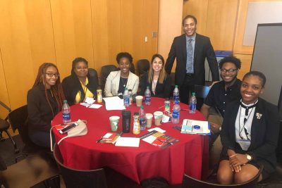 Students attending the NSMH Eastern Regional Conference sit around a round table